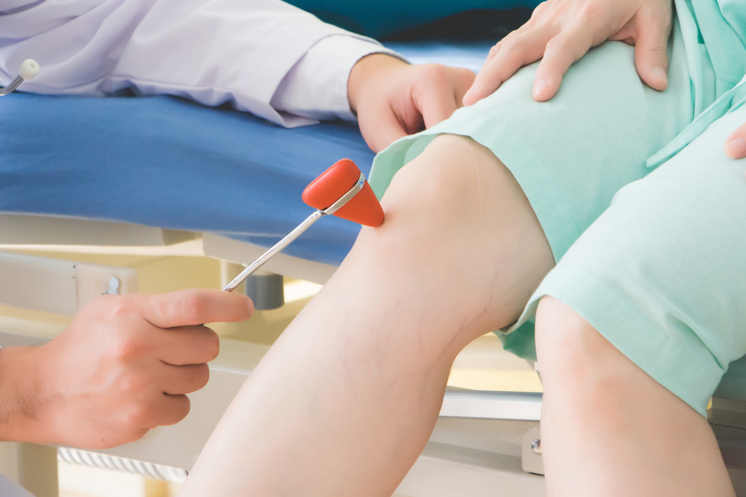 The doctor is using a hammer to knock the elderly patient to test the reaction, which is controlled by the autonomic nervous system. The force of the knock will cause the thigh muscles to stretch.